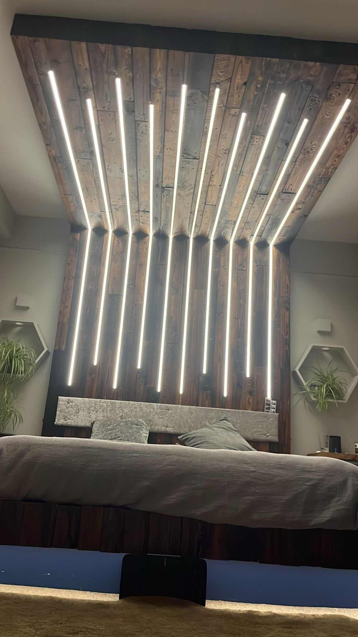 Close angle on a bespoke headboard with radiating ceiling LED strips